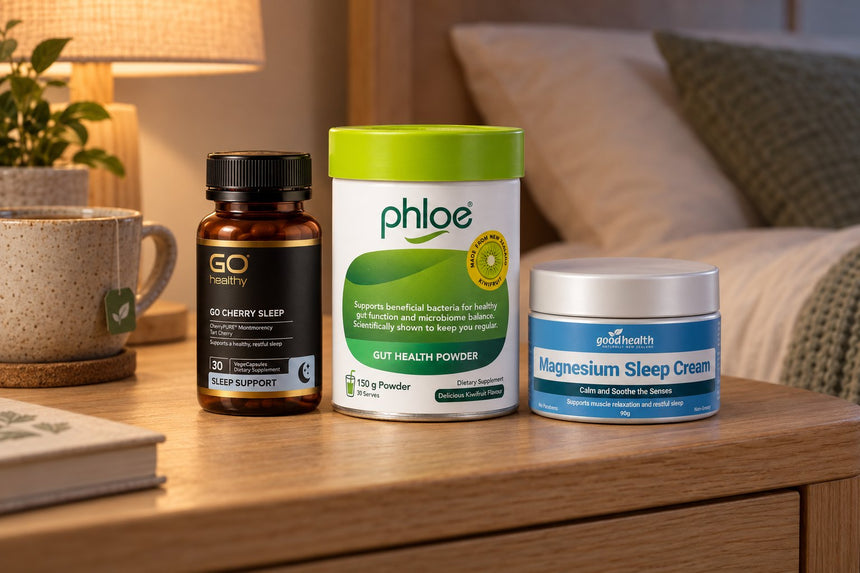 Phloe Gut Health Powder, GO Cherry Sleep and Good Health Magnesium Sleep Cream on a bedside table in evening lamplight