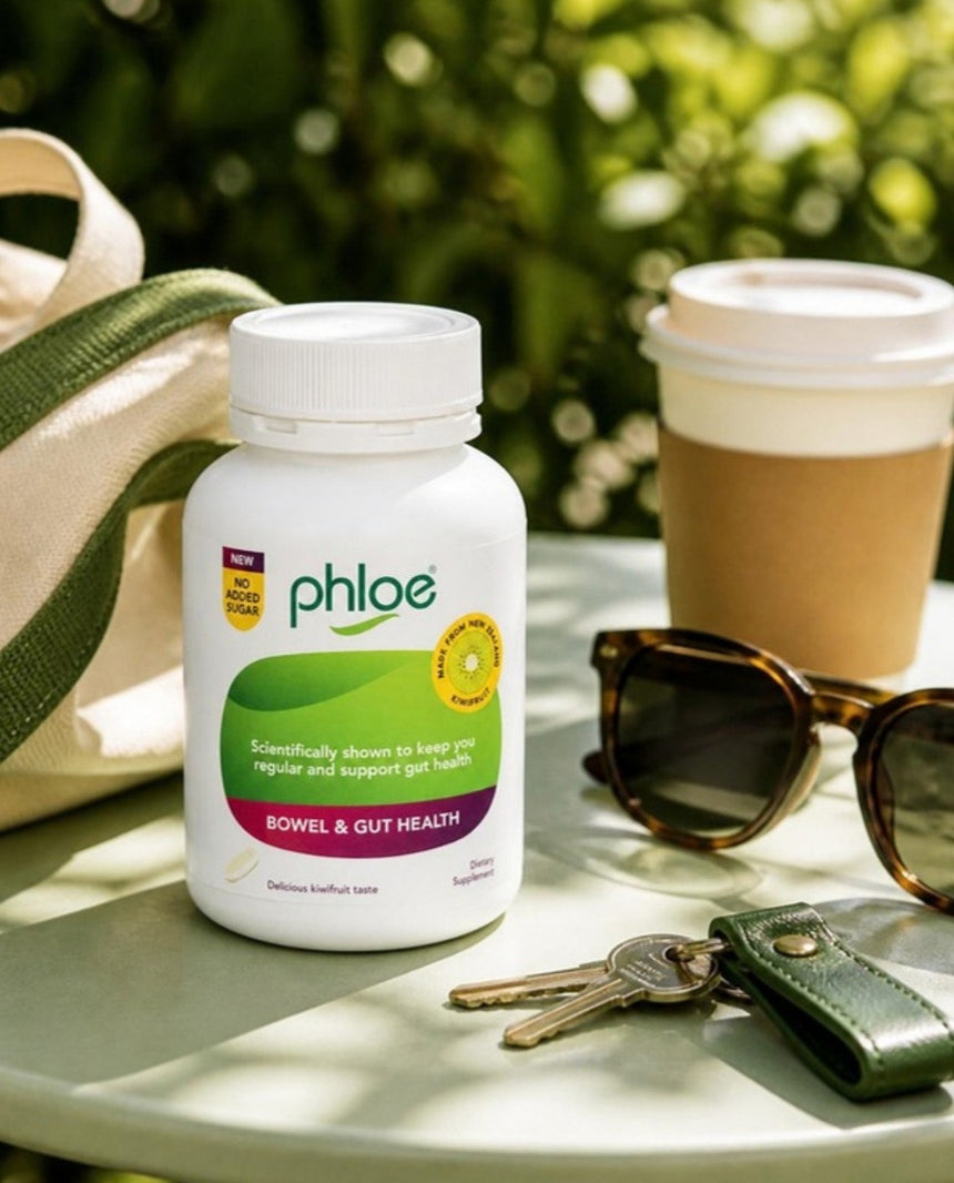 A Phloe No Added Sugar Chewables bottle on a café table with keys, coffee and sunglasses