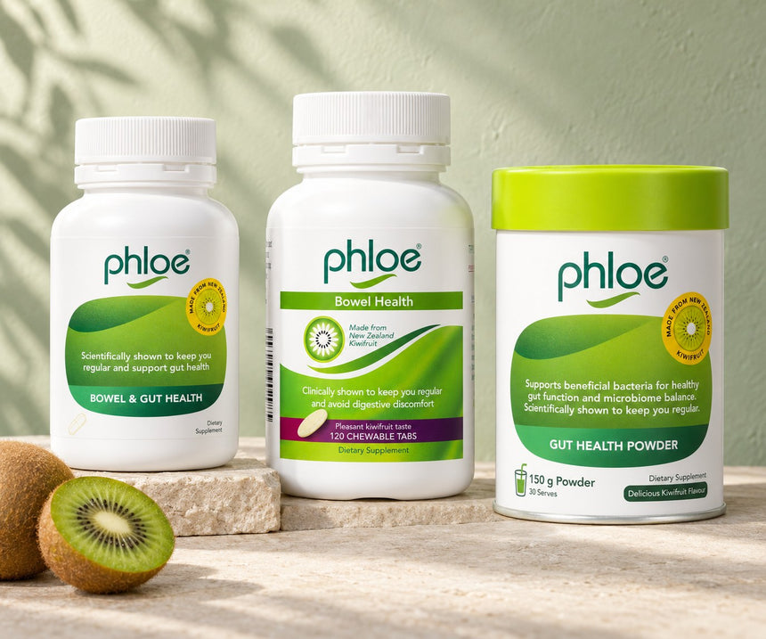 Phloe Capsules, Chewables and Gut Health Powder on a stone ledge with halved kiwifruit